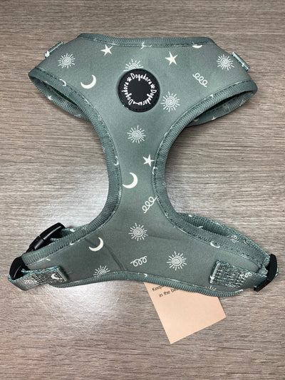 Dogadora fully adjustable dog harness. In a green design with beige stars, moons and suns with a swirly pattern. Soft and padded
