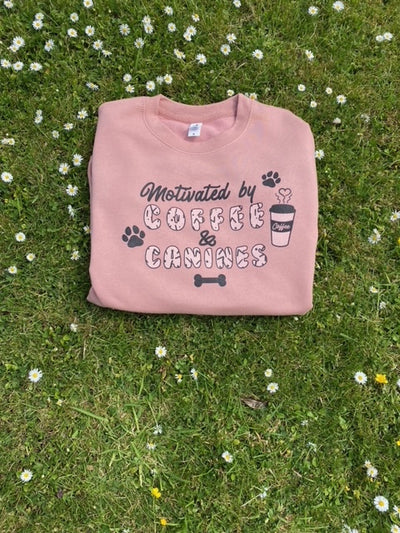 Dusky pink unisex sweatshirt with 'Motivated by coffee & canines' design