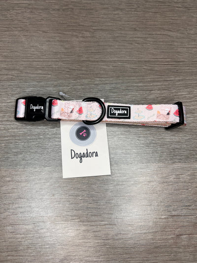 Adjustable dog collar with watermelons, picnic basket, pawsecco, strawberries, cakes and flowers on a neautral background. finished off with a branded rubber logo and plastic clip. Metal D ring for lead attachment